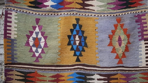 Details of traditional Turkish carpet in Istanbul shop, Turkey. Close up of Middle Eastern Arabian carpets in market store. photo