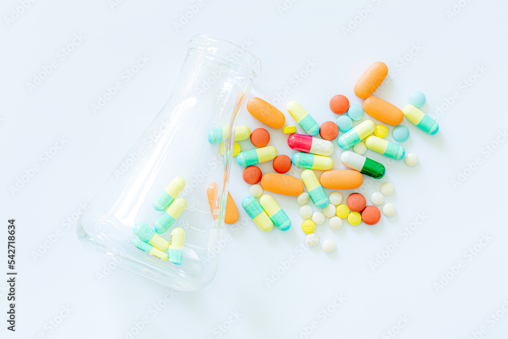 Medical: Pills and bottle, aerial view ,drug trials and pill bottles,science experiment flask Medical: Pills and bottle, aerial view ,drug trials and pill bottles,science experiment flask