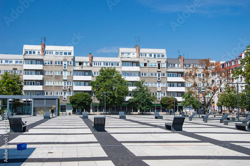 Wroclaw square lined with concrete elements and benches. Summer.