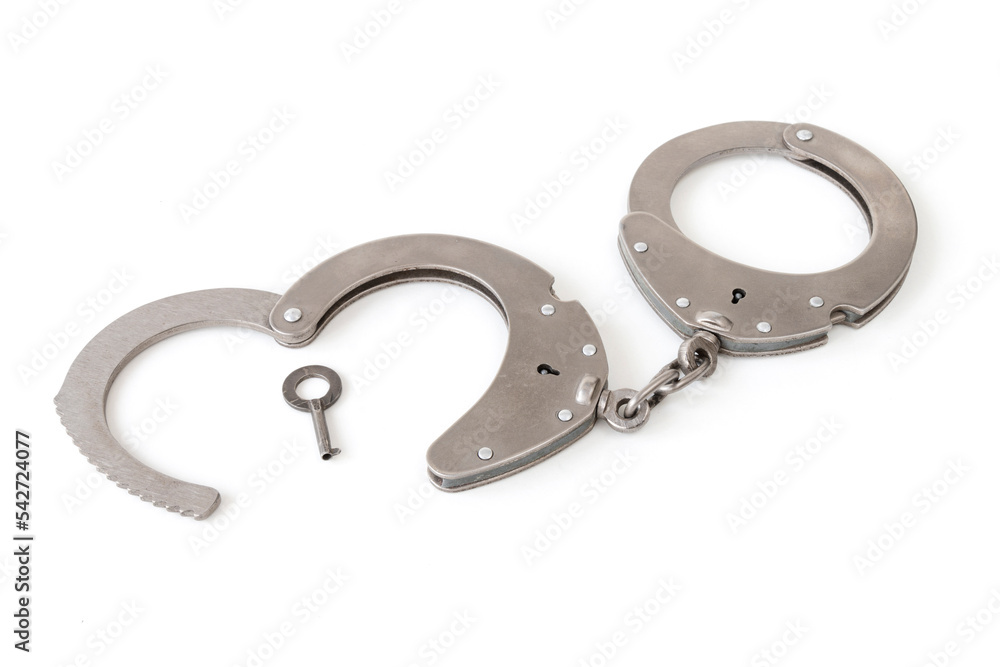 handcuffs with a key in the form of a heart, on a white isolated background handcuffs with a key in the form of a heart, on a white isolated background