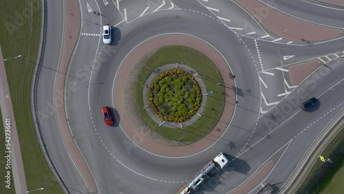 Roundabout aerial top view with cars passing by
