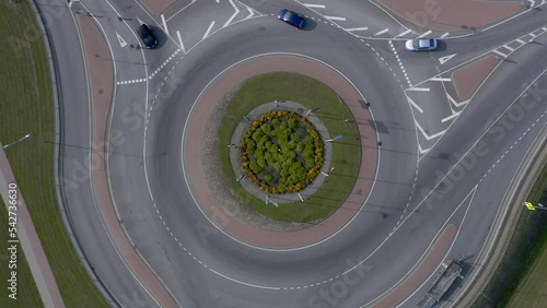 Roundabout aerial top view with cars passing by