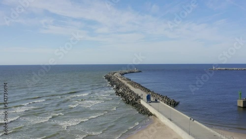 Sea wave breaker with lighthouse aerial view