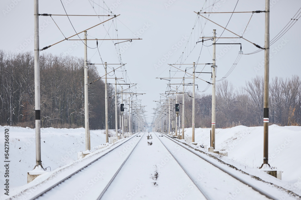 Snowy railway during winter frosty day. Diminishing perspective of two empty railroad tracks. Snowy railway during winter frosty day. Diminishing perspective of two empty railroad tracks.