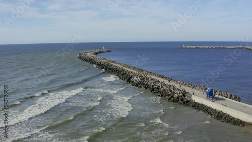 Sea wave breaker with lighthouse aerial view