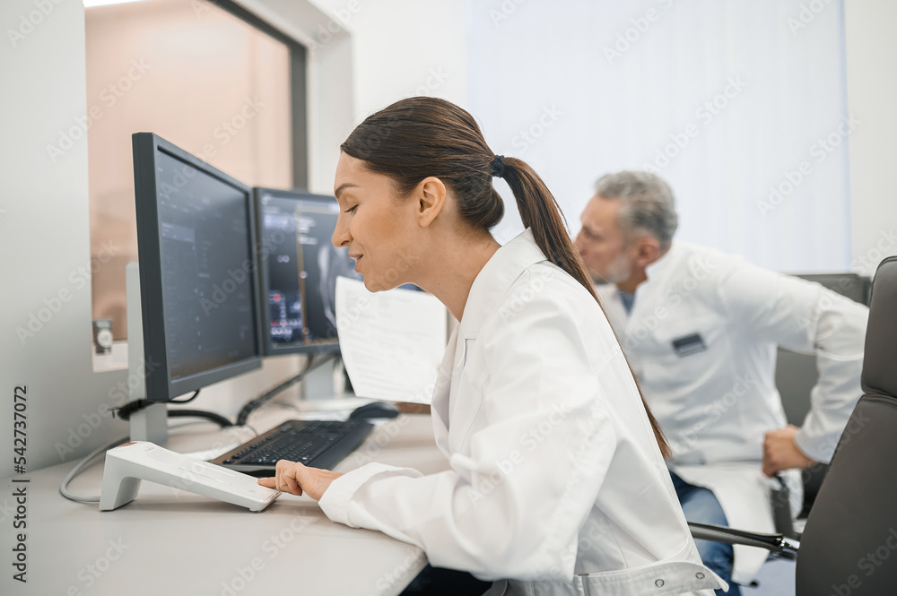 Doctors working in the diagnostic center and looking involved Doctors working in the diagnostic center and looking involved