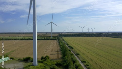 Wind turbines towers on electricity farm spinning and producing green energy