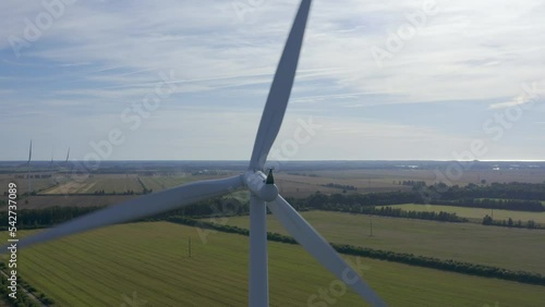 Wind turbines towers on electricity farm spinning and producing green energy