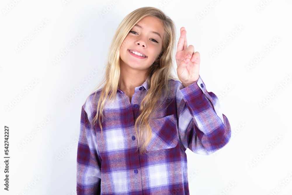beautiful caucasian teen girl wearing plaid purple shirt over white wall pointing up with fingers number ten in Chinese sign language Shi beautiful caucasian teen girl wearing plaid purple shirt over white wall pointing up with fingers number ten in Chinese sign language Shi