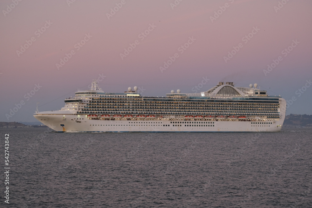 Princess cruiseship or cruise ship liner Ruby P in San Francisco port Bay terminal sail away cruising with Sausalito skyline twilight blue hour sunset sky Alcatraz Golden Gate sailing boats yachts