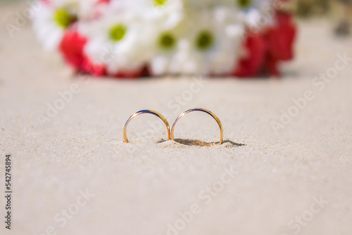 Engagement wedding rings and bouquet on beach. Background with copy space web banner template. Wedding concept, honeymoon