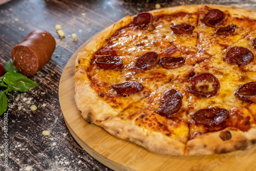Pizza Sucuk delicous and fresh out of the oven with sucuk sausage and Ingrediens on table