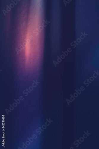 Blue and orange background. Abstract background with light and shadows over stucco wall. Moody painting style long exposure photography. © Naya Na
