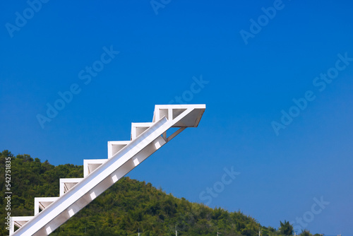 White stair with background is blue sky and mountain