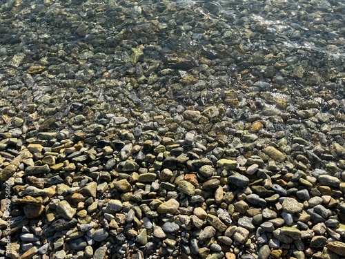 sea pebbles, transparent sea water with rocky bottom