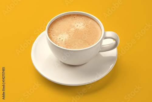 A cup of coffee on a yellow background. cappuccino