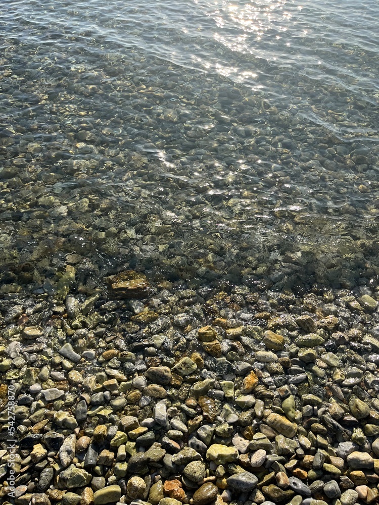 sea pebbles, transparent sea water with rocky bottom sea pebbles, transparent sea water with rocky bottom