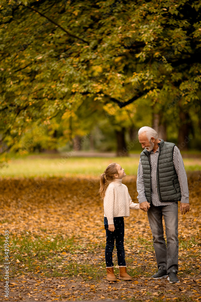 © BGStock72 - Grandfather spending time with his granddaughter in park on autumn day