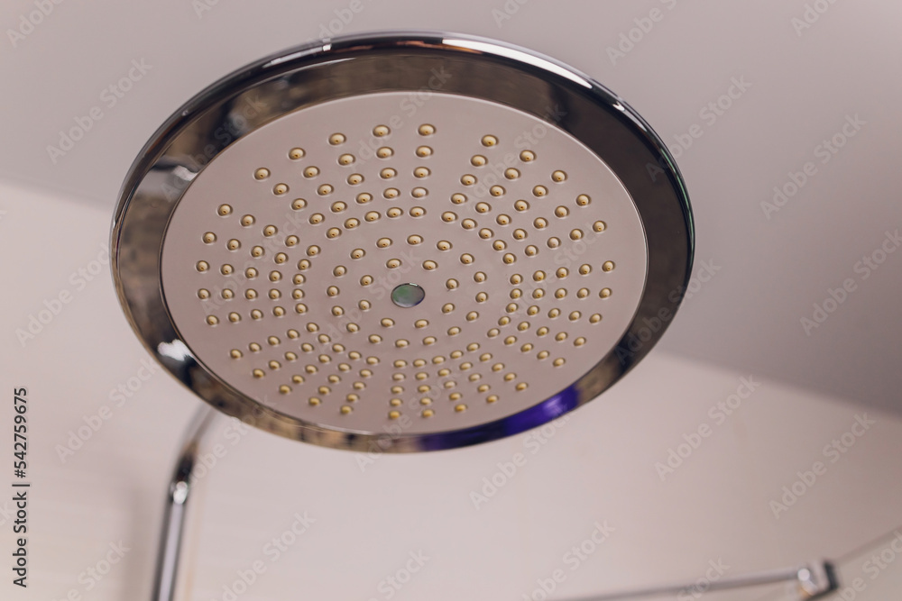 In the bathroom, open shower mixer has attached to the wall bracket ...
