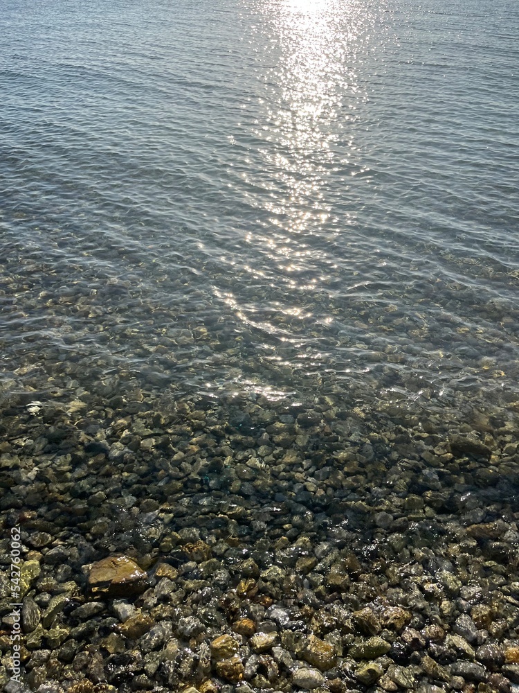 sea pebbles, transparent sea water with rocky bottom