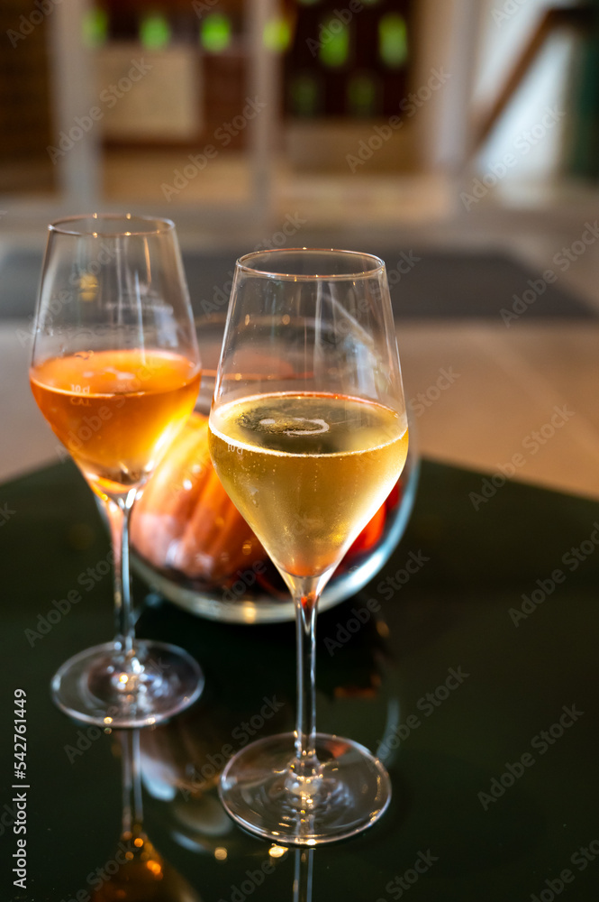Tasting of brut and rose champagne sparkling wine produced by traditional method in underground caves in Champagne, France