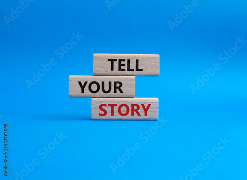 Tell your story symbol. Wooden blocks with words Tell your story. Beautiful blue background. Business and Tell your story concept. Copy space.