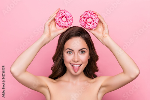 Photo of funky childish young nude lady wear nothing mickey mouse donuts showing tongue isolated pink color background