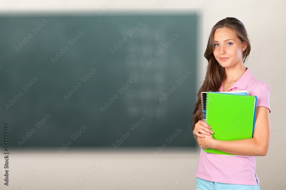 Smiling happy female student in classroom Smiling happy female student in classroom