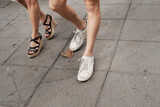 legs of people walking on the sidewalk