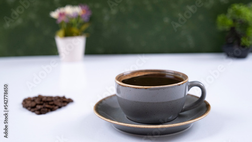 Image of coffee mug and coffee beans on a white background