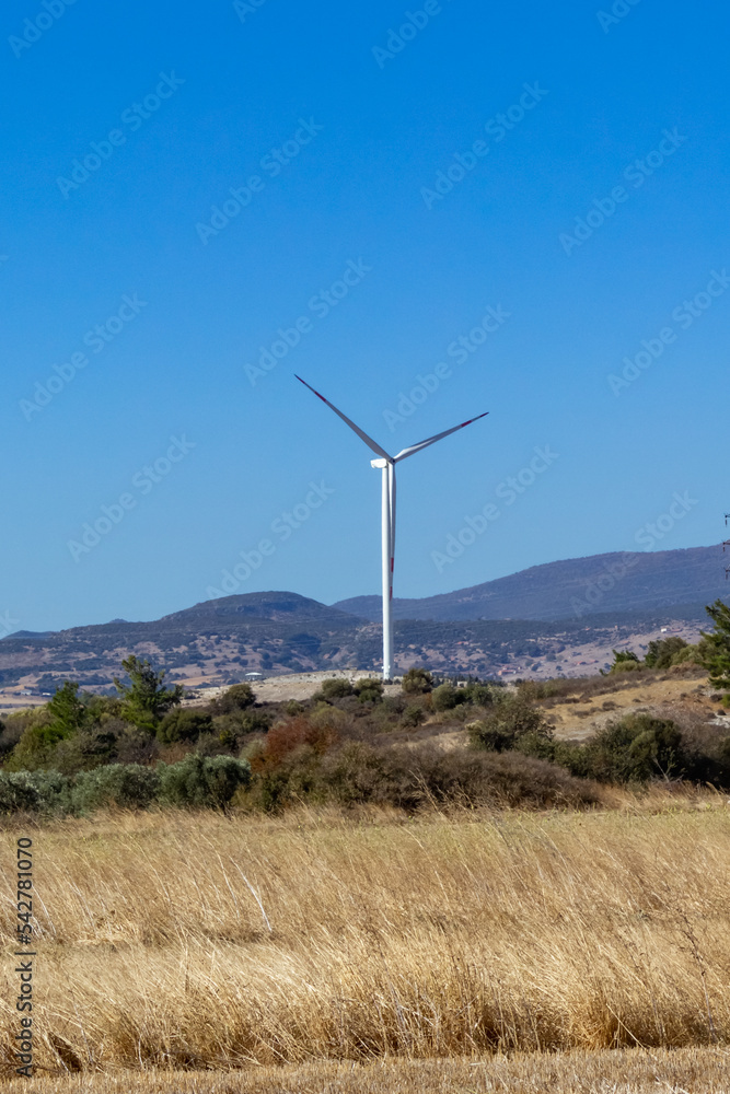 A beautiful landscape with wind turbines against a cloudless sky. A beautiful landscape with wind turbines against a cloudless sky.