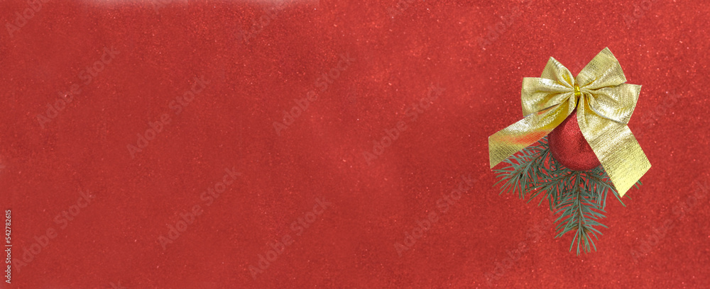 Branch of Christmas tree is hanging with red glitter ball and golden bow on red shiny background. Concert of Christmas backgrounds. Branch of Christmas tree is hanging with red glitter ball and golden bow on red shiny background. Concert of Christmas backgrounds.
