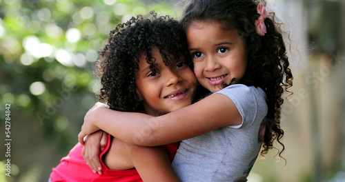 Valokuvatapetti Hispanic siblings embrace and hug. Two sisters love