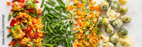 Frozen vegetable mix banner, frozen green beans and broccoli, corn and carrots, brussels sprouts and cauliflower, peas and bell peppers, copy space, top view