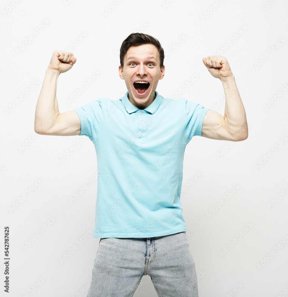 Yes. Emotional man shouting shaking fists standing over white background. Yes. Emotional man shouting shaking fists standing over white background.