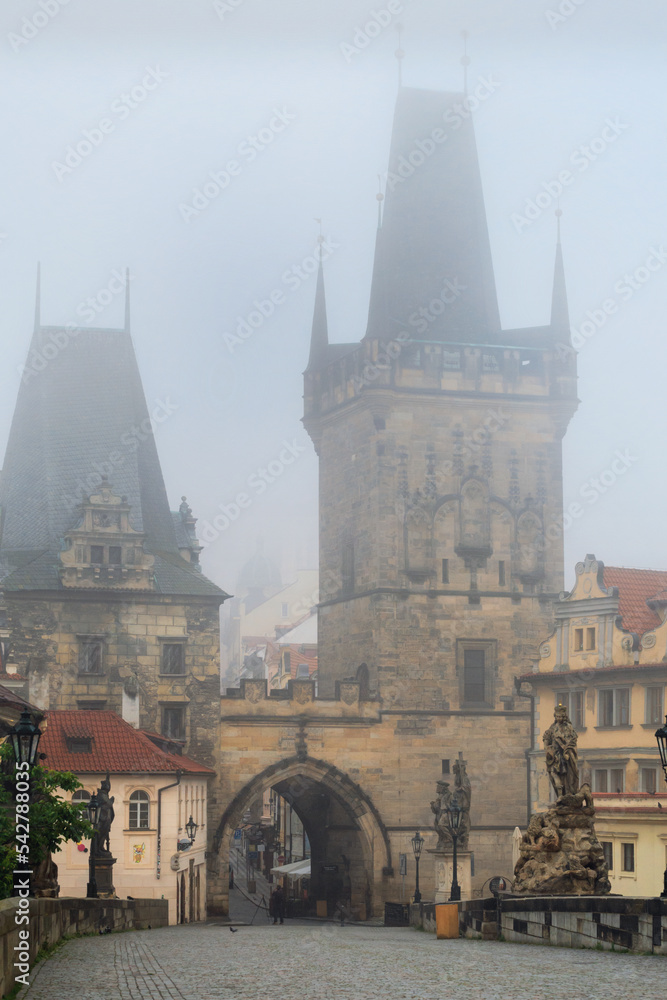 Fototapeta premium Cityscape - view of the Malа Strana Bridge Tower from the Charles Bridge in the early morning, Prague, Czech Republic