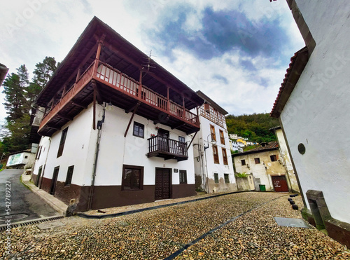 Cangas del Narcea, El Cascarin district where is El Carmen chapel and the roman bridge next to Narcea river, Asturias, Spain photo