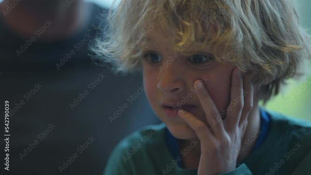 One contemplative little boy hand on chin thinking One contemplative little boy hand on chin thinking