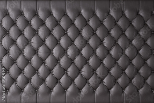 Black genuine leather upholstery, chesterfield style background. 3D rendering