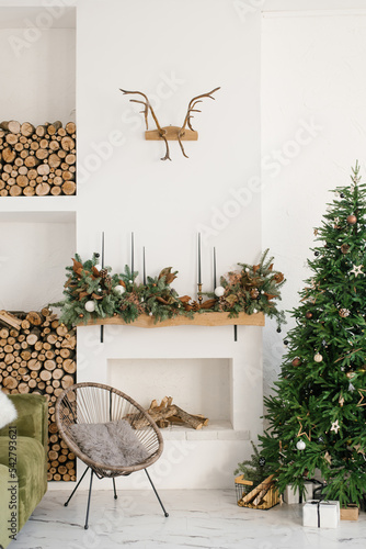Christmas tree with gifts in the house. Scandinavian interior of the room. Fireplace with gifts in the house. New Year's cozy living room interior