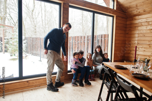 Large family in modern wooden house spending time together in warm and love.