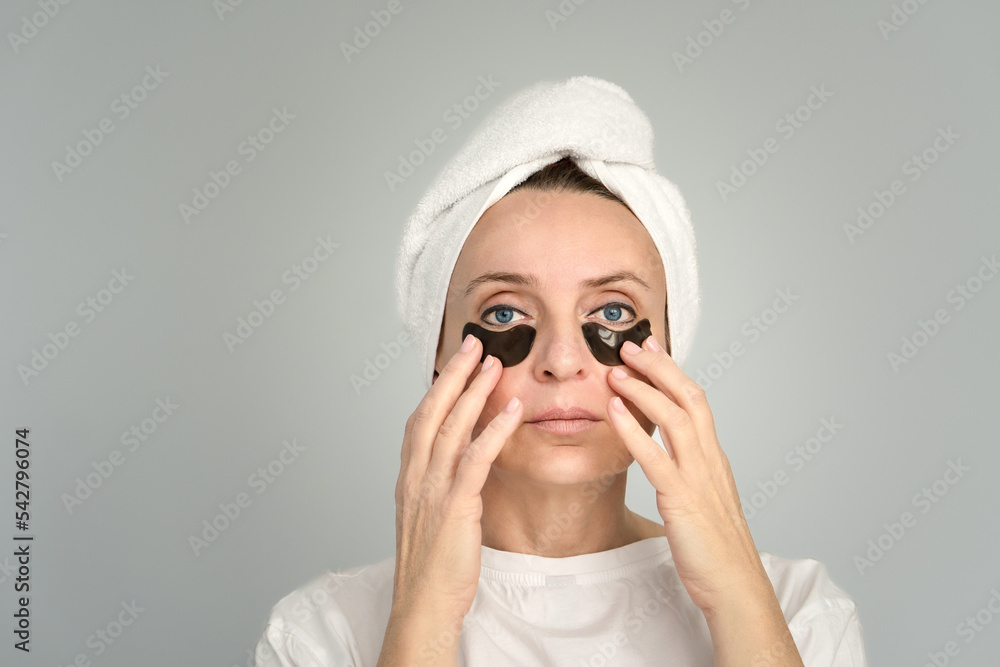 Portrait of a woman with a towel on her head. Facial care . Portrait of a woman with a towel on her head. Facial care .