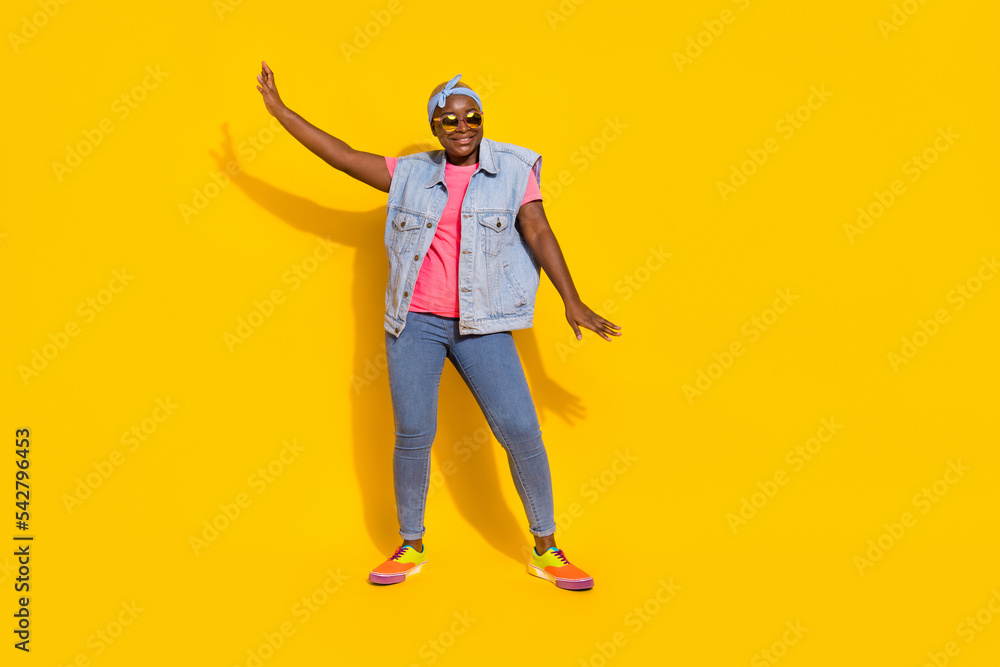 Fototapeta premium Full size portrait of cheerful excited lady enjoy discotheque dancing isolated on yellow color background