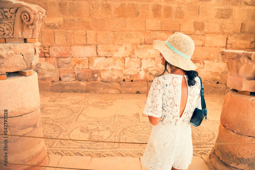 Petra, Jordan - 7th october, 2022: Caucasian woman tourist inside byzantine church stand explore historical remains of mosaics
