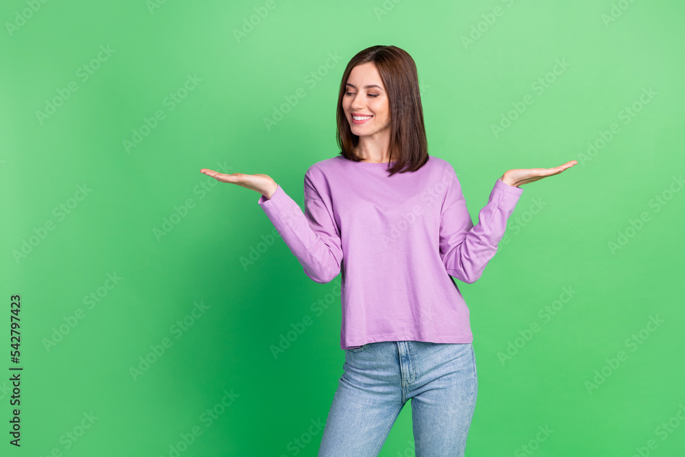 Photo of young gorgeous optimistic bob hairstyle young lady hold demonstrating object isolated on green color background Photo of young gorgeous optimistic bob hairstyle young lady hold demonstrating object isolated on green color background
