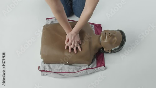 shot from above of person doing cpr on a mannequin photo