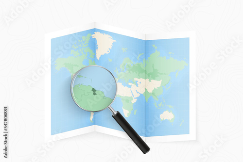 Enlarge Guyana with a magnifying glass on a folded map of the world.