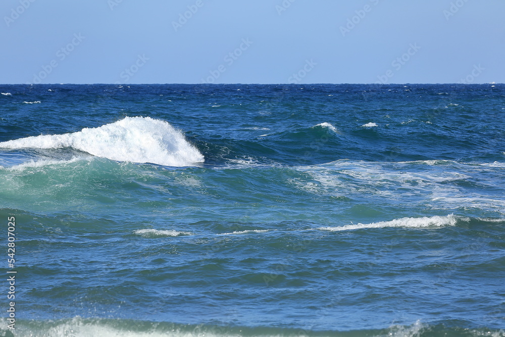 Look at the beautiful waves on the beach of Jeju Island.