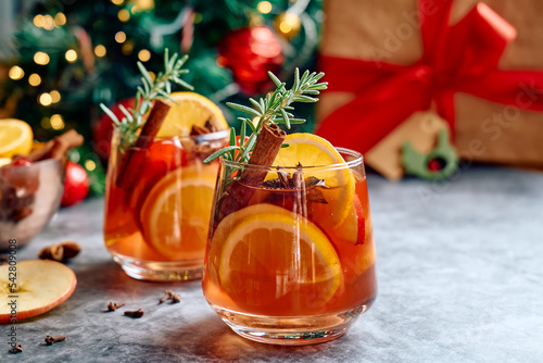 Mulled wine or christmas sangria with aromatic spices, apple, cherry and citrus fruits. Traditional Christmas festive warming spiced drink with orange, berry, cinnamon, cardamom and anise.