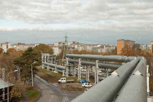 Photography pipeline, in the photo the pipeline is close-up, in the background the city and